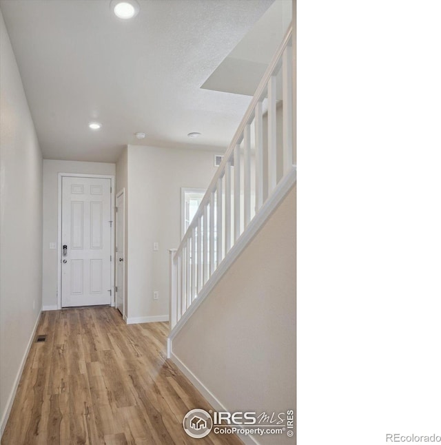 foyer with light hardwood / wood-style flooring