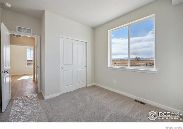 unfurnished bedroom with light colored carpet