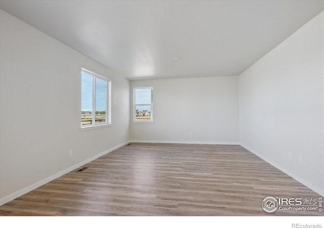 spare room with light hardwood / wood-style flooring