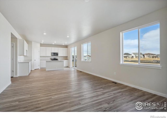 unfurnished living room with light wood-type flooring