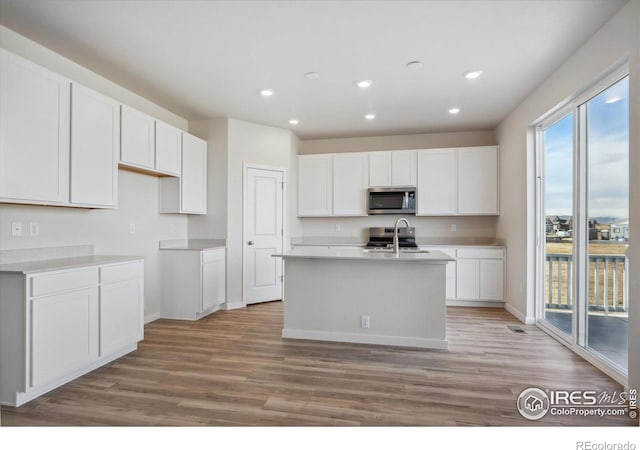 kitchen featuring light hardwood / wood-style flooring and white cabinetry