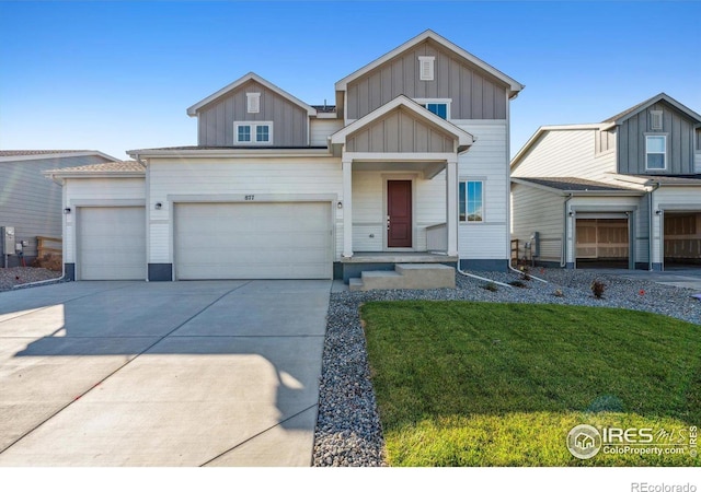 view of front of house featuring board and batten siding, driveway, a front yard, and a garage