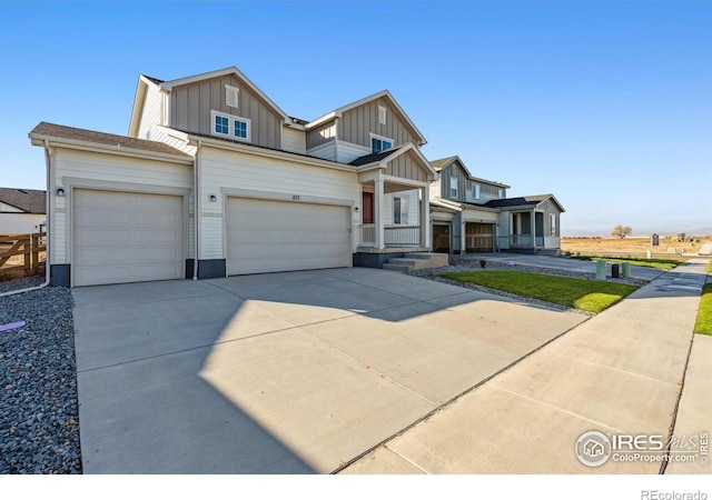 view of front of home featuring board and batten siding, driveway, and a garage