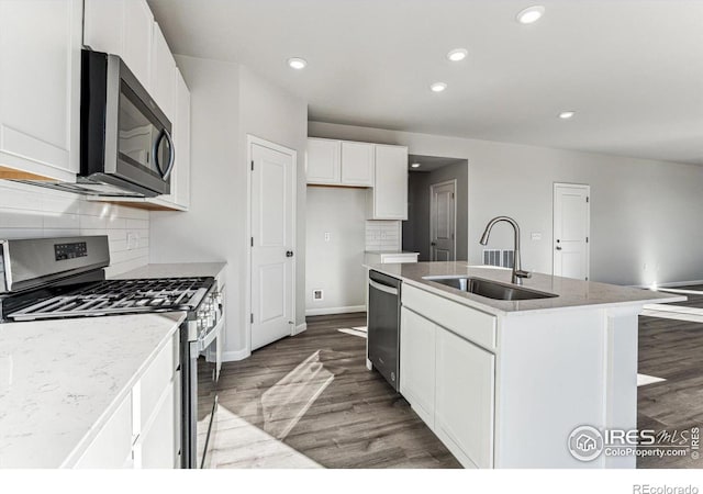 kitchen featuring appliances with stainless steel finishes, sink, a center island with sink, and hardwood / wood-style floors