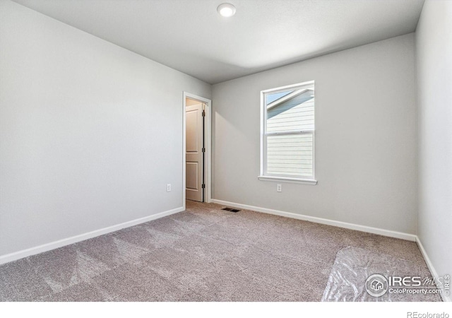 unfurnished bedroom featuring carpet, visible vents, and baseboards
