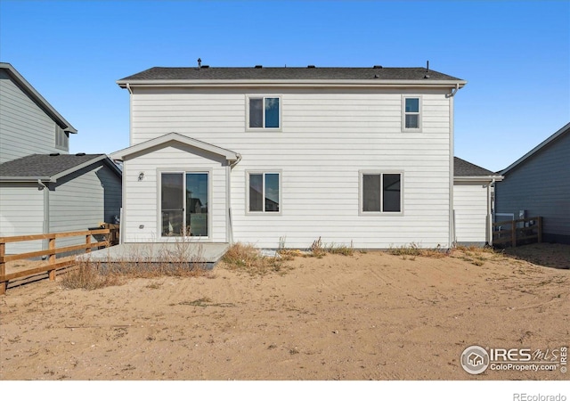 back of house with fence