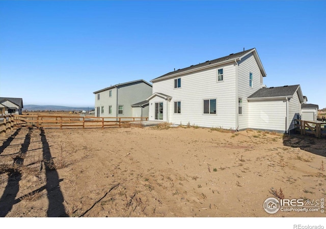 back of property with fence