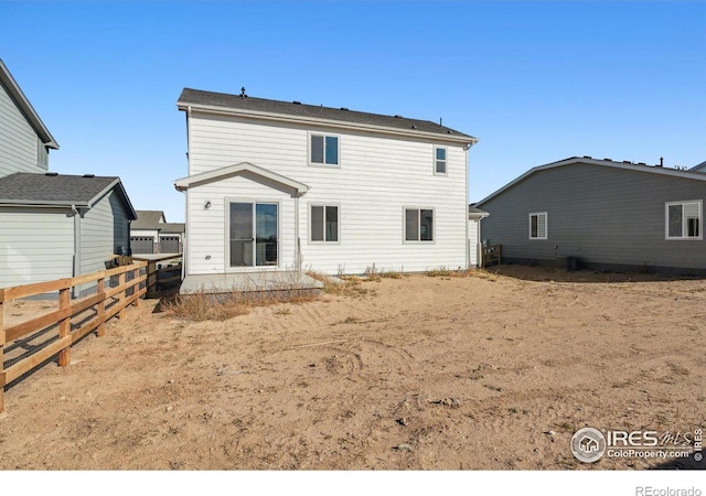 rear view of house with fence