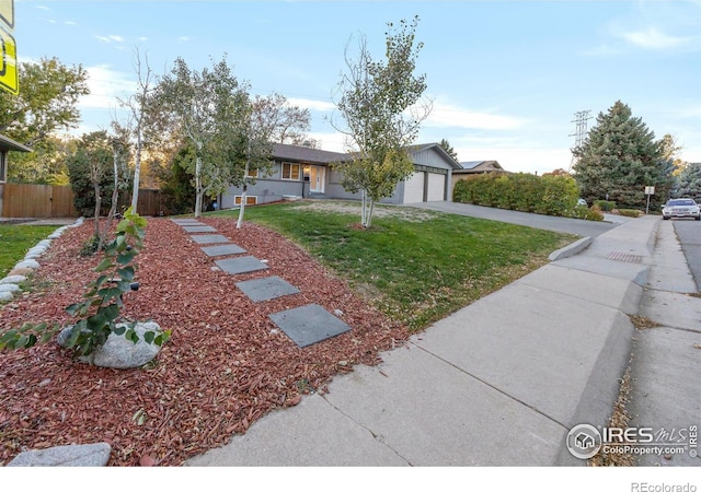 view of front of house featuring a front lawn and a garage