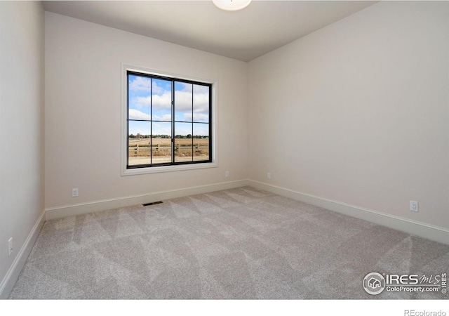 empty room featuring light colored carpet