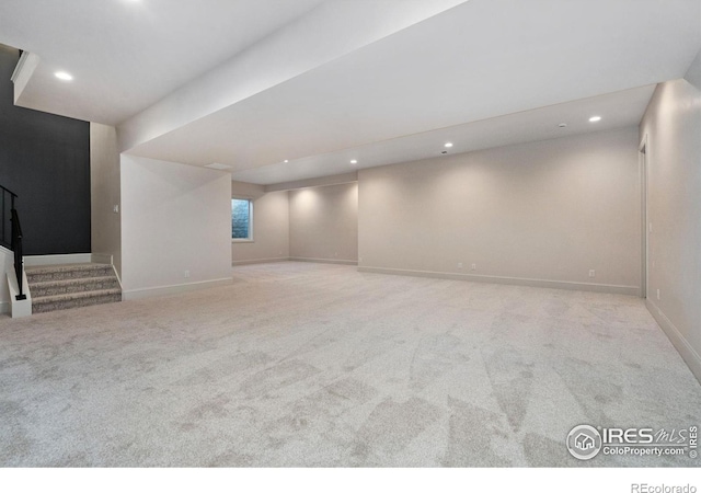 basement featuring light carpet