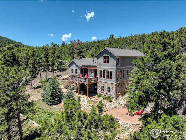 rear view of property featuring a wooden deck