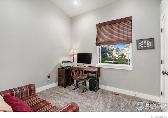 office space with vaulted ceiling and light carpet