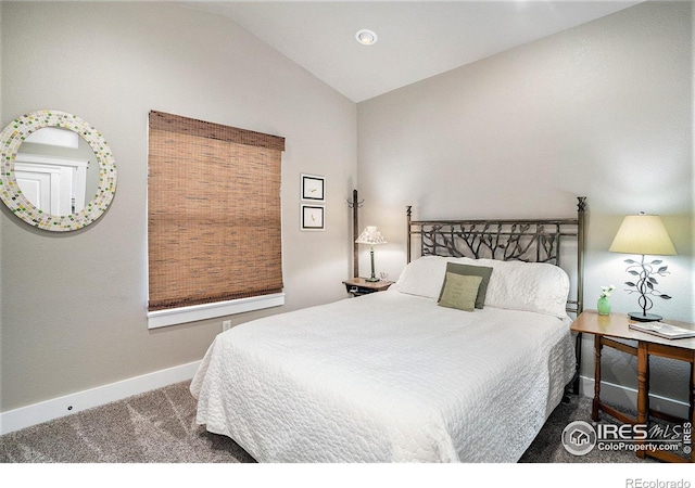 carpeted bedroom with lofted ceiling