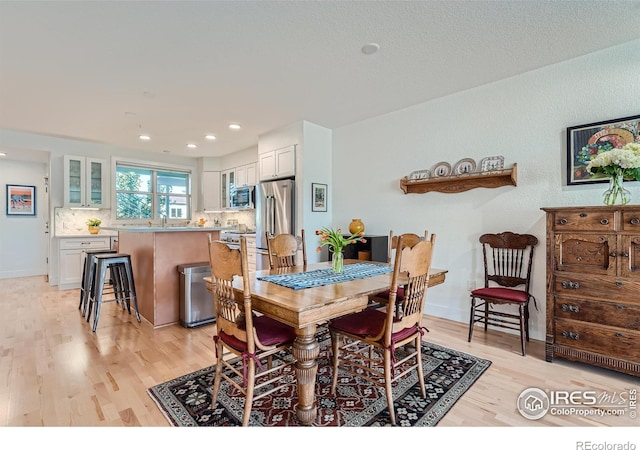 dining area featuring light hardwood / wood-style floors and sink