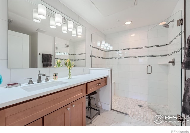 bathroom featuring vanity and an enclosed shower