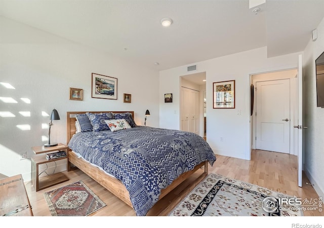 bedroom featuring a closet and light wood-type flooring