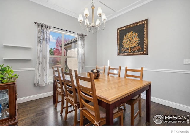 dining area with ornamental molding, a notable chandelier, and dark hardwood / wood-style floors