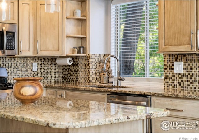 kitchen featuring sink, decorative backsplash, appliances with stainless steel finishes, and plenty of natural light