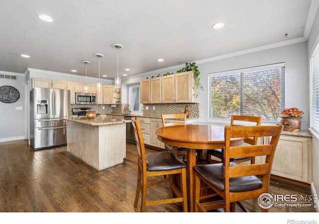 dining room featuring ornamental molding and dark hardwood / wood-style flooring