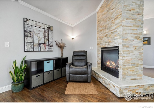 sitting room with ornamental molding, dark wood-type flooring, and a fireplace