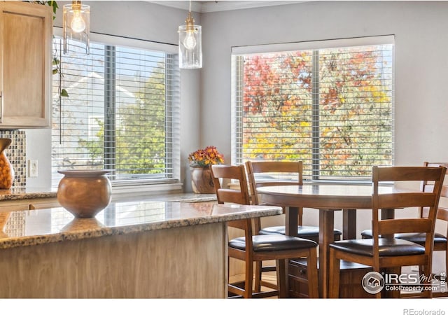 dining area featuring crown molding