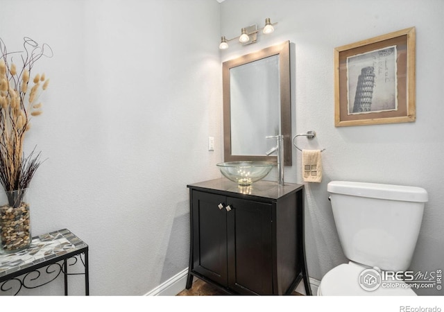 bathroom featuring vanity and toilet