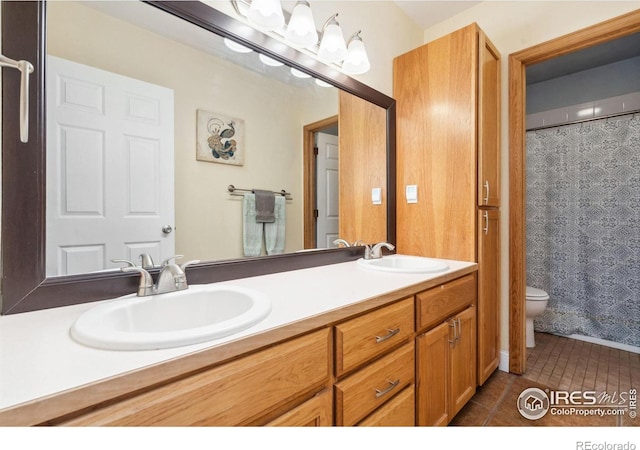 bathroom featuring vanity, curtained shower, toilet, and tile patterned floors