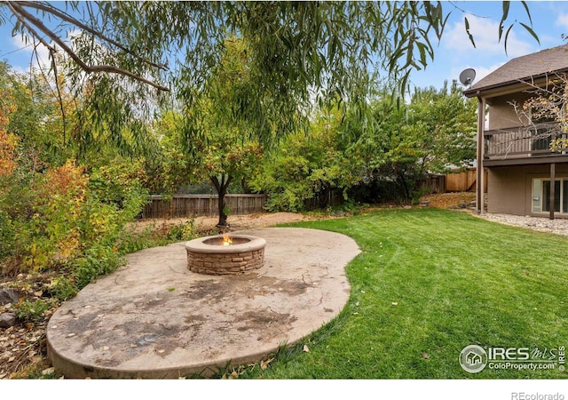 view of yard featuring a patio and an outdoor fire pit