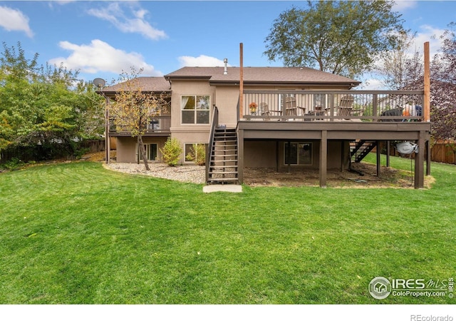 rear view of property with a yard and a wooden deck