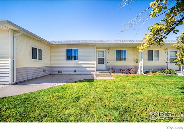 view of front of home with a front yard and a patio area