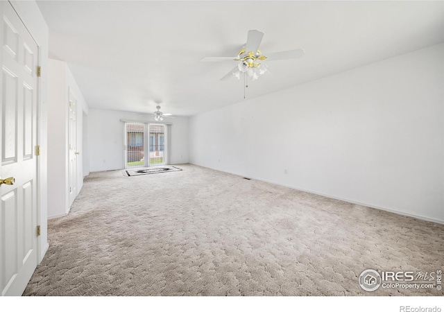 carpeted spare room featuring ceiling fan