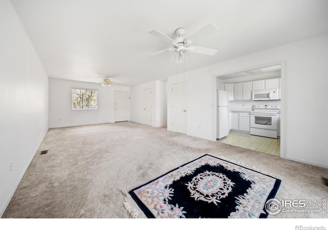 unfurnished living room with ceiling fan