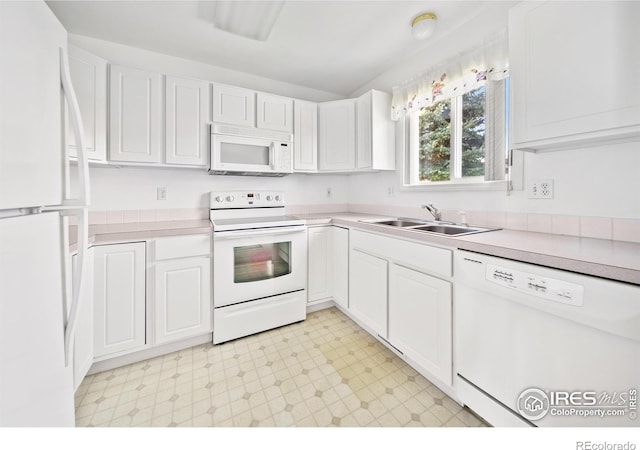 kitchen with sink, white cabinets, and white appliances