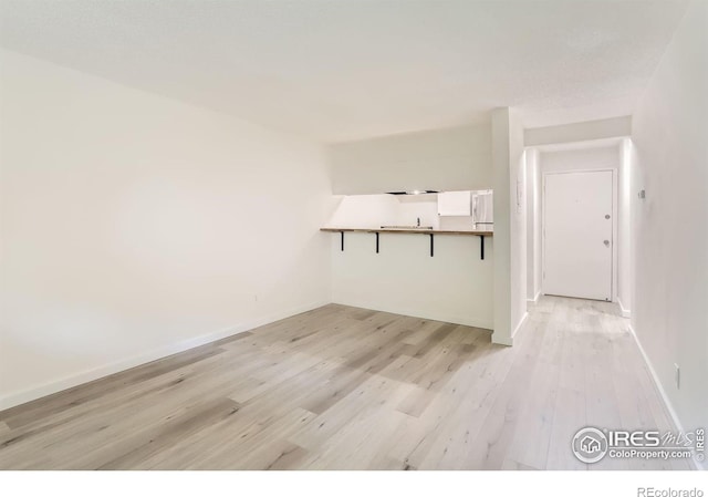 empty room with light hardwood / wood-style flooring