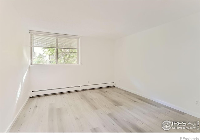 spare room with light hardwood / wood-style flooring and baseboard heating