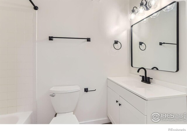 full bathroom with toilet, tiled shower / bath combo, and vanity