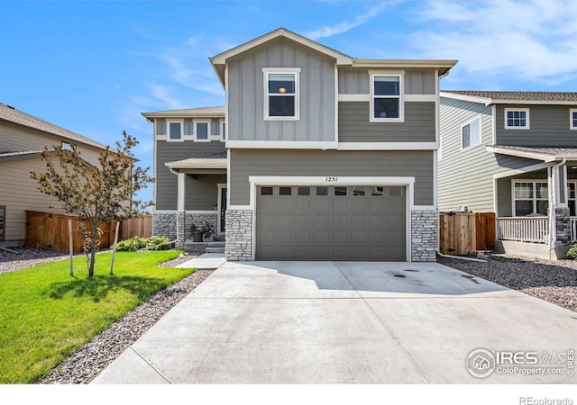 view of front of property featuring a garage and a front lawn