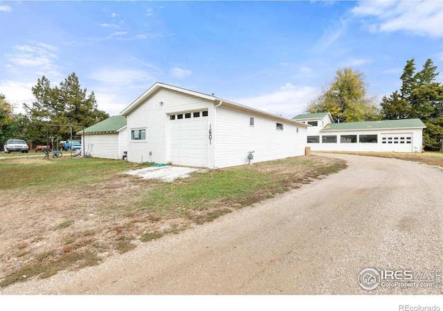 1601 E 1st St, Loveland, CO 80537 - view of property exterior with an outdoor structure and a garage