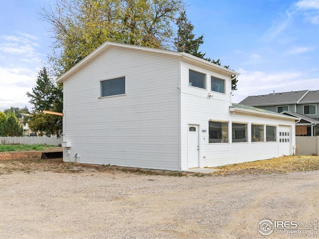 1601 E 1st St, Loveland, CO 80537 - view of side of home featuring a sunroom and fence