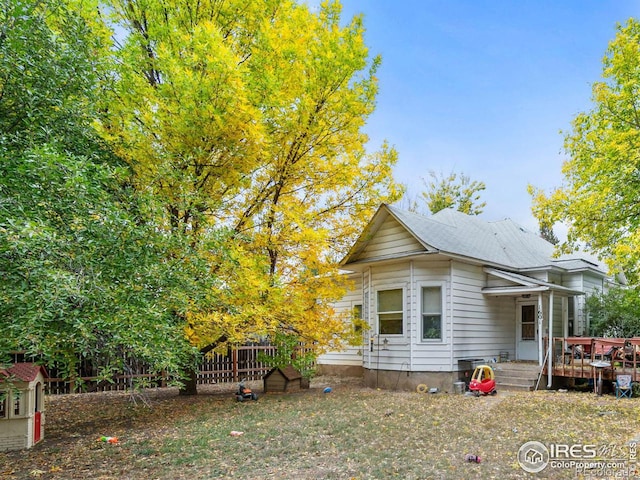 rear view of house with a wooden deck