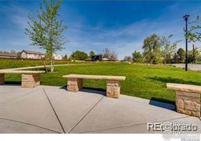 surrounding community featuring a patio and a lawn