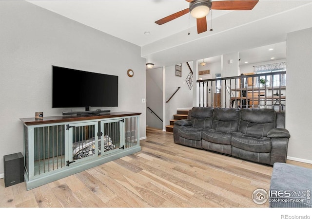 living room with hardwood / wood-style floors and ceiling fan