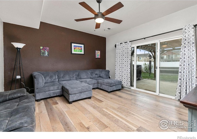 living room featuring hardwood / wood-style flooring and ceiling fan