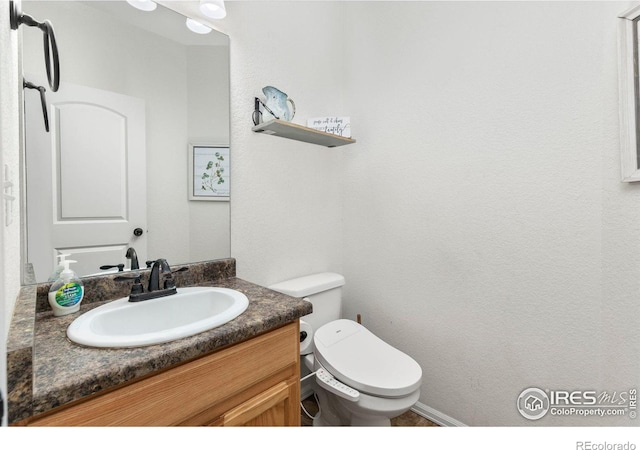 bathroom with vanity and toilet