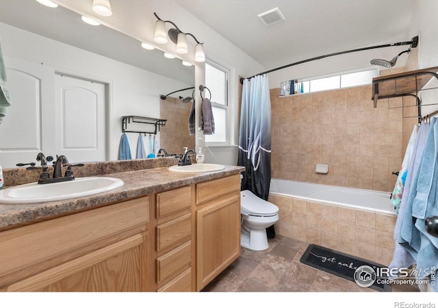 full bathroom featuring shower / bath combination with curtain, toilet, and vanity