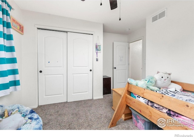 bedroom featuring a closet, ceiling fan, and carpet