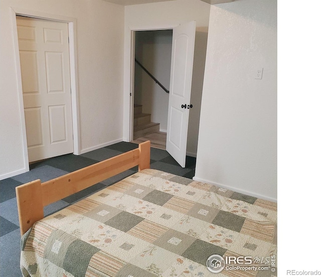 bedroom featuring dark carpet