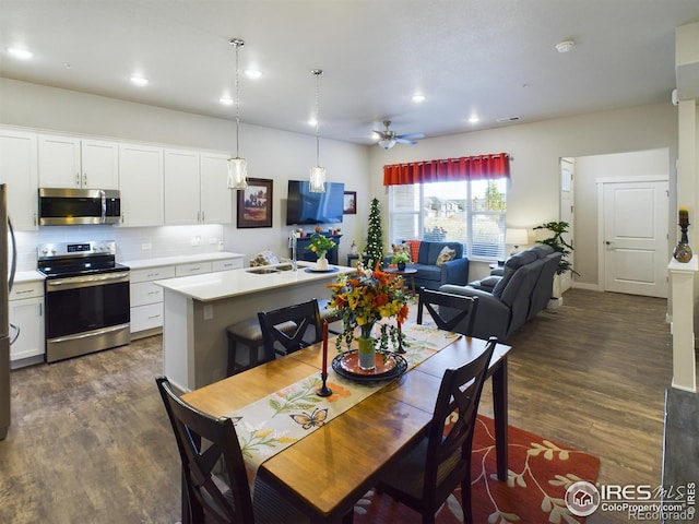 dining room featuring dark hardwood / wood-style floors and ceiling fan