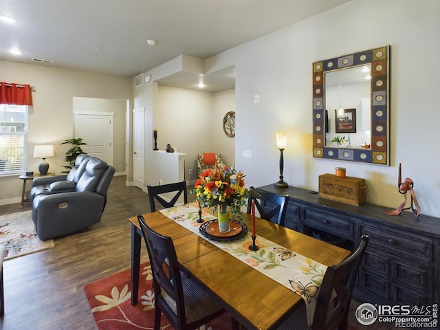 dining space featuring dark wood-type flooring